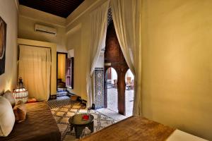a living room with a couch and an open door at Hotel & Spa Dar Bensouda in Fez