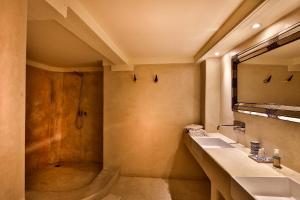 a bathroom with a sink and a shower at Hotel & Spa Dar Bensouda in Fez