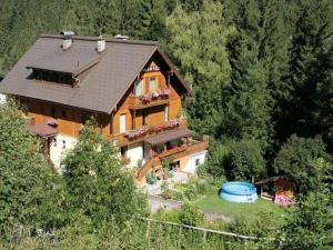 a large wooden house in the middle of a forest at Waldhaus in Sankt Martin am Tennengebirge
