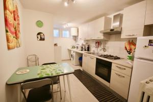 a small kitchen with a table and a refrigerator at Relaxing and Comforting in Olbia