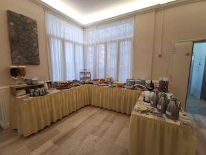 a group of tables with food on them in a room at Hotel Milani in Lido di Camaiore
