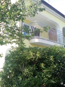 a balcony on the side of a house at Ana Rooms in Krk