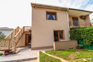 a house with a staircase in front of it at Apartments Magla with Terrace in Baška