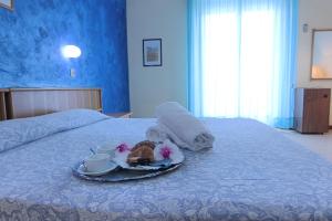 Postel nebo postele na pokoji v ubytování Grand Hotel Excelsior