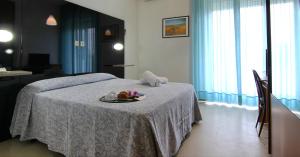 Postel nebo postele na pokoji v ubytování Grand Hotel Excelsior