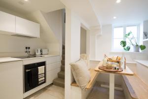 a small kitchen with a table and a counter at Grade II Listed Townhouse in heart of the City - FREE DESIGNATED PARKING in Bath