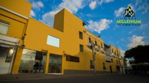a yellow building on the side of a street at Hotel Millenium Victoria Plaza in Cúcuta