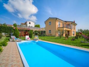 an image of a swimming pool in front of a house at Apartment Daria by Interhome in Labin