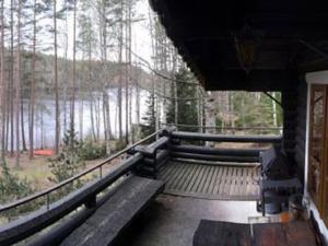 a room with benches and a view of a forest at Holiday Home Sokeelampi by Interhome in Matku