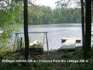 a boat on a dock in the middle of a lake at Holiday Home Suvikumpu by Interhome in Tuusmäki