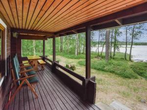 a porch of a cabin with a view of the water at Holiday Home Mäntyranta by Interhome in Harjula