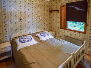 1 dormitorio con 1 cama con 2 almohadas en Holiday Home Leppäranta by Interhome, en Harjula