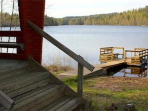 a wooden dock on a lake with a dock at Holiday Home Hirviharju by Interhome in Torsansalo