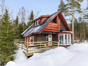 a log cabin in the woods in the snow at Holiday Home Hästöskata b by Interhome in Kruunupyy