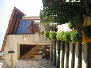 a building with plants on the side of it at Pazo A Freiria in Puebla de Trives