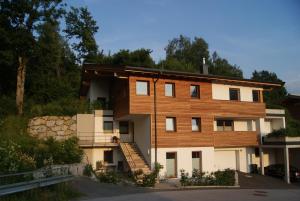 ein Haus mit einer Holzfassade und einer Treppe in der Unterkunft Ferienwohnung Genner in Kitzbühel