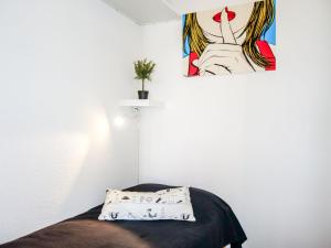a room with a bed with a painting on the wall at Apartment Les Trois Mousquetaires by Interhome in Saint-Palais-sur-Mer