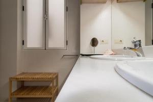 a white bathroom with a sink and a mirror at Style Peydro Apartament. Center-Wifi in Valencia