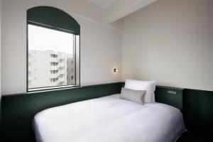 Postel nebo postele na pokoji v ubytování DDD HOTEL
