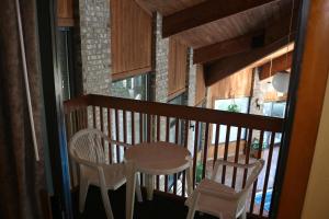 a balcony with two chairs and a table on it at Baymont by Wyndham Washington Court House in Jeffersonville
