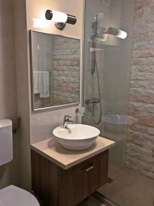a bathroom with a sink and a shower at Lira Holiday Apartments in Eforie Nord +38 photos