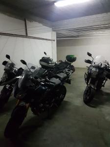 a row of motorcycles parked in a garage at Motel Maksumić in Jablanica
