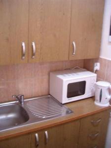 a microwave sitting on a counter next to a sink at MOSiR Reda in Reda