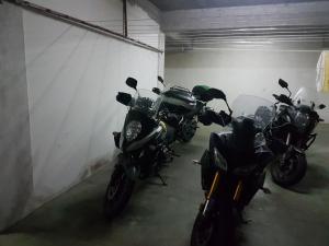a row of motorcycles parked in a garage at Motel Maksumić in Jablanica