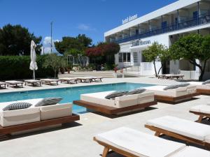 a swimming pool with lounge chairs and a hotel at Danae Hotel in Egina