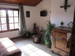 a bedroom with a bed and a tv in a room at la cle des champs in Saou