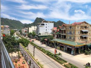 a city street with buildings and mountains in the background at Starlet Hotel Phong Nha in Phong Nha