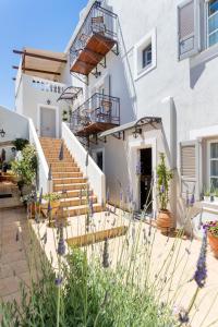 una casa con escaleras y flores delante en Guesthouse Niriides, en Spetses