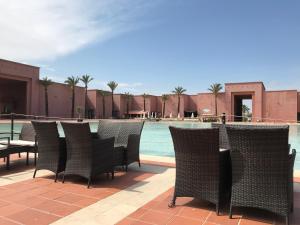 a group of chairs sitting next to a swimming pool at Condado de Alhama in Alhama de Murcia +8 photos