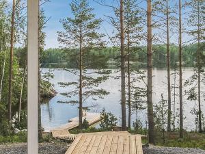 a view of a lake with a wooden dock at Holiday Home Koholahti by Interhome in Jäniskylä