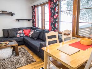 a living room with a couch and a table at Holiday Home Karhunvartijan linna a3 by Interhome in Ruka