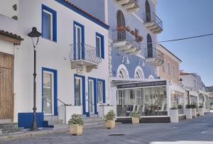 a street with a blue and white building at GrindiSuite Relais de Chambre in Santa Teresa Gallura