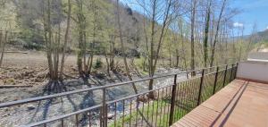 a balcony with a view of a river and trees at Casa Alba in Ribes de Freser