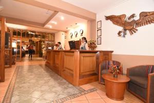 a lobby of a pharmacy with two people at a counter at Hotel Prisma Cusco in Cusco