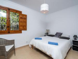 a bedroom with a bed and a chair and a window at Villa Aurelie by Interhome in Balcon del Mar +15 photos