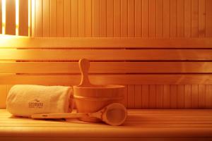 a bathroom with a toilet brush and a towel at Sesimbra Oceanfront Hotel - Preferred Hotels and Resorts in Sesimbra