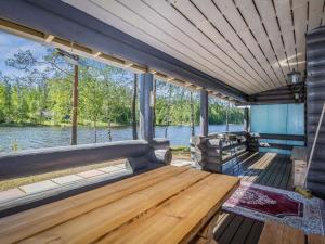 a wooden bench on the back of a boat at Holiday Home Aurinkoniemi by Interhome in Anttola