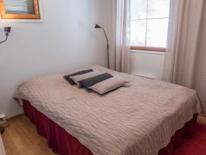 a bedroom with a bed with two pillows on it at Holiday Home Karhunvartijan linna a7 by Interhome in Ruka