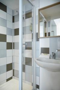 a bathroom with a sink and a shower at Hôtel Saint Louis - Vieux Port in Marseille