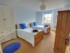 a bedroom with two beds and a window at Holiday Home Ferndale House by Interhome in Lynmouth