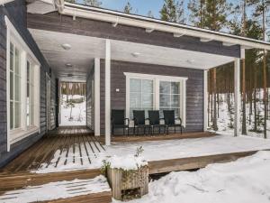 a porch of a house in the snow at Holiday Home Koholahti by Interhome in Jäniskylä