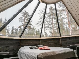 a room with a bed in front of a window at Holiday Home Arctic light hut by Interhome in Kakslauttanen