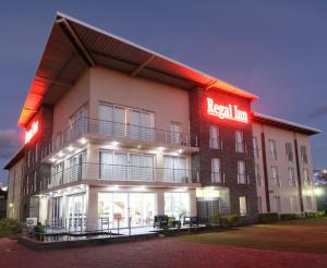 a building with a red real inn sign on it at Regal Inn Ballito in Ballito