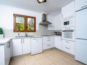 a white kitchen with white appliances and a window at Villa Aurelie by Interhome in Balcon del Mar