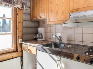 a kitchen with a sink and a counter top at Holiday Home Vuokatticottage e by Interhome in Kukkola