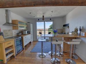 a kitchen with a counter and a table with chairs at Holiday Home Ferndale House by Interhome in Lynmouth